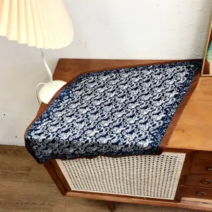 Detailed view of a stylish navy blue paisley pleated neckerchief and vintage scarf design.
