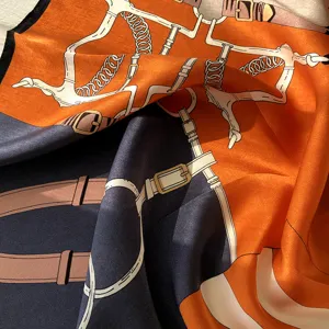Luxury silk scarf for women featuring elegant equestrian strap and belt print in orange dark grey.