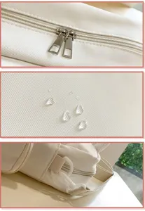 Close-up details of casual canvas cross-body bag showing smooth zippers, waterproof fabric.
