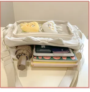 White ita bag with clear window, cat ear design and spacious interior capacity for daily use.