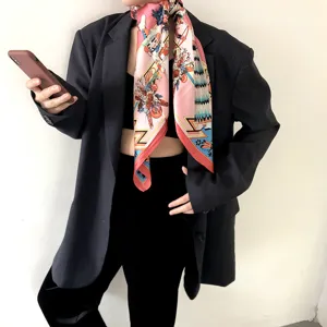 Detailed shot of a luxury silk square scarf with colorful prints, elegant silk neckwear piece.