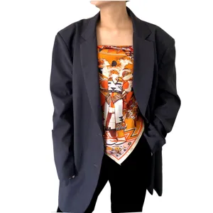 Luxury silk square scarf with tribal print, styled as a chic top with an oversized blazer.