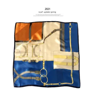 Luxurious mulberry silk square scarf featuring classic equestrian strap and buckle design details.