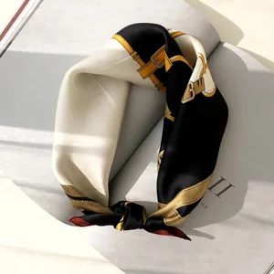 Detailed shot of luxury black white silk scarf featuring elegant vintage belt and strap print design.