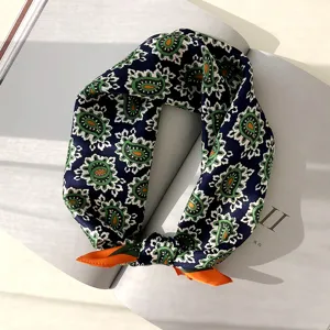 Gedetailleerde close-up van een donkerblauwe paisley zijden sjaal, elegante accessoire.