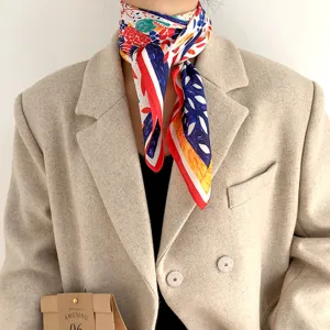 Detailed view of women's artistic silk scarf with vibrant crayon print and elegant drape.