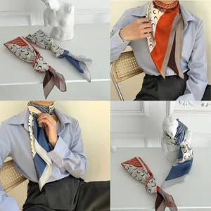 Chic silk square scarf featuring iconic crescent moon print and stylish color block design.