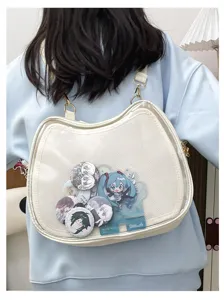 Details of white cat ita bag showcasing anime badges and acrylic standee for fans and cosplay.