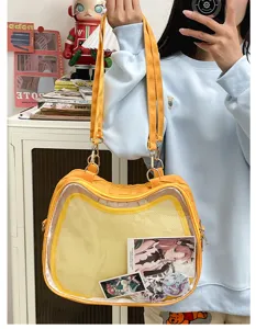 Yellow cat ita bag detail view, showing transparent window for anime pins and photo cards.