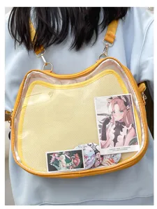 Clear cat ita bag detail view showing transparent window for displaying anime pins and postcards.