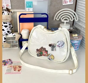 White clear window ita bag cat shaped shoulder crossbody bag with cute anime badges display.
