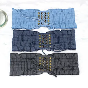 Women wide denim elastic waist belt with metal grommets lace-up and ruffled hem dress cinch.
