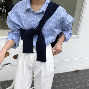 Women striped long sleeve shirt with navy knit shawl and white trousers casual set detail