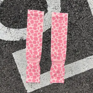 Summer cooling ice silk arm sleeves for outdoor sun protection with pink spotted pattern.