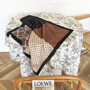 Detailed view of the luxury silk square scarf featuring elegant mixed patchwork patterns.