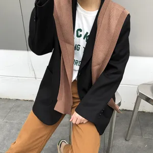 Detail view of stylish knitted shoulder shawl paired with blazer for women daily outfit.