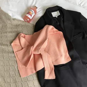 Detailed view of women knitted solid color shrug shawl flat lay scene styling outfit.