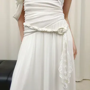 White braided waist belt detail shot, elegant lace hanging design for stylish dresses or pants.