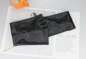 Black faux leather wide waist belt, stylish corset accessory for dresses and suits detail shot.
