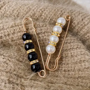 Exquisite pearl and rhinestone safety pin brooch for clothing decoration and waist adjustment.