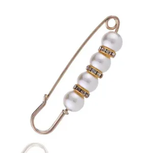 Pearl rhinestone safety pin detail shot, golden metal waist tightening brooch decor.