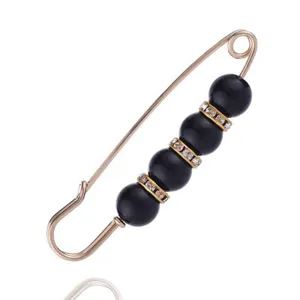 Adjustable waist safety pin with black beads and rhinestones for dresses and jeans styling.