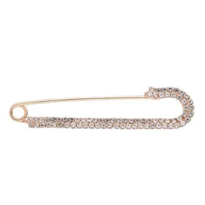 Rhinestone safety pin brooch detail, sparkling crystal embellishment for waist adjustment.