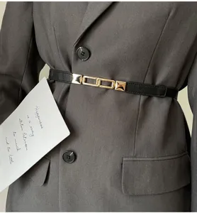 Minimalist black thin waist belt with metal chain buckle detail for blazer dress accent.