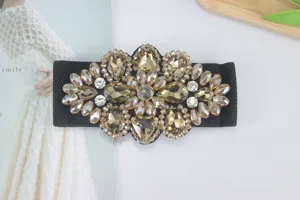Close-up of sparkling crystal rhinestone elastic waist belt buckle, perfect dress accessory.