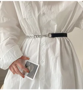 Close-up view of women's fashion waist belt featuring black elastic band and silver metal chain link.