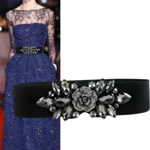 Wide elastic waist belt for women, featuring a stunning crystal rhinestone flower buckle design.