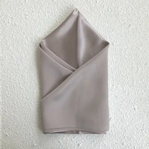 Exquisite solid color silk square scarf detail, premium mulberry silk material, elegant taupe sheen.