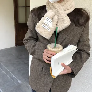 Beige faux fur winter scarf for women, warm plush neck warmer with stylish fabric label detail.
