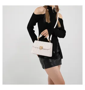 Chic white quilted shoulder bag with heart lock clasp showcased in detail style view.