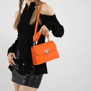 Orange quilted shoulder bag for women, stylish crossbody bag with cute heart lock clasp.