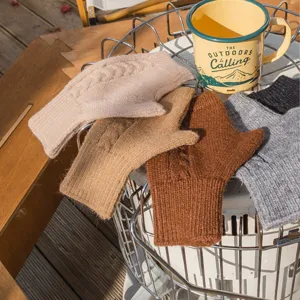 Close-up detail of cozy knit fingerless gloves in multiple colors displayed on outdoor camping gear.