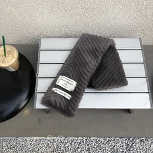 Dark grey plush winter scarf detail view featuring stylish aesthetic fabric labels for cozy warmth.