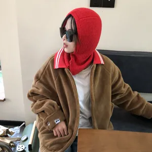 Closeup view of red knitted balaclava hood with striped collar and cozy brown fuzzy zip jacket.