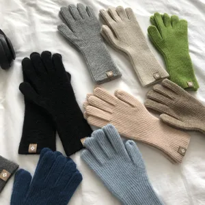 Detailansicht von Damen-Strickhandschuhen in verschiedenen Farben für den Winter.