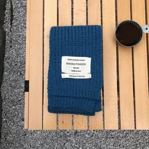 Blauer Strick-Winterschal mit einfarbigem Stoffetikett, kuscheliges und warmes Modeaccessoire.
