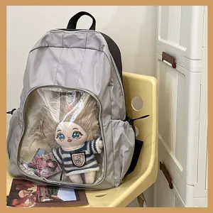 Clear ita backpack detail showing doll display window, casual student daypack school bag.