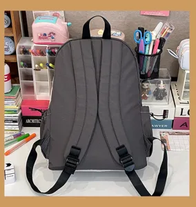 Grey canvas backpack for students, casual daily commuter school bag with adjustable straps.