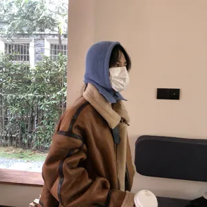 Detailed view of winter knitted balaclava hood scarf combo in stylish blue color cozy wear.