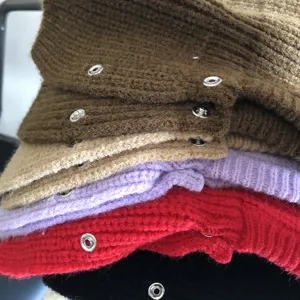 Knitted balaclava hood detail view, cozy winter neck warmer and snap button woolen hat design.