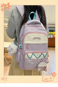 Mochila escolar morada grande y elegante para ninas con bonito colgante y bolsillos.