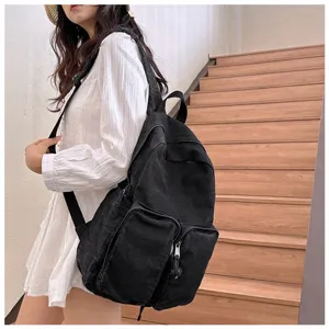 Detailed view of black denim backpack, vintage Japanese casual school bag for daily commute.