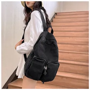 Minimalist black denim backpack detailed view, casual retro school bag for daily use.
