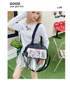 Black shoulder crossbody ita bag with clear display window, stylish anime badge bag for women.