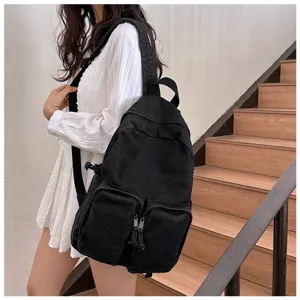 Black canvas casual backpack detail, vintage Japanese style school bag with front pockets.
