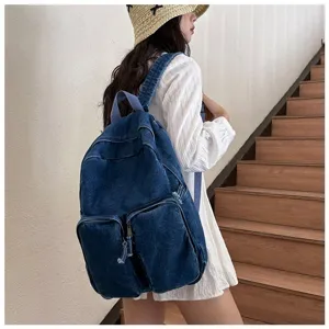 Vintage blue denim backpack scene showing multi-pocket design and casual everyday student style.